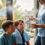 Family cooling down during extreme hot weather in Calgary with chilled water and a cool, air-conditioned indoor setting in the background.