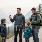 “Family checking air quality before hiking in Invermere with hazy wildfire smoke visible over the valley mountains.”